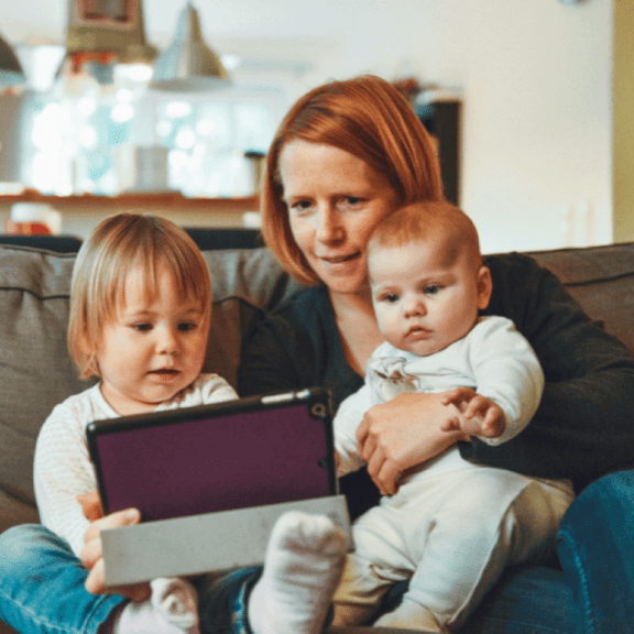 photo of a woman and two small children watching a Service