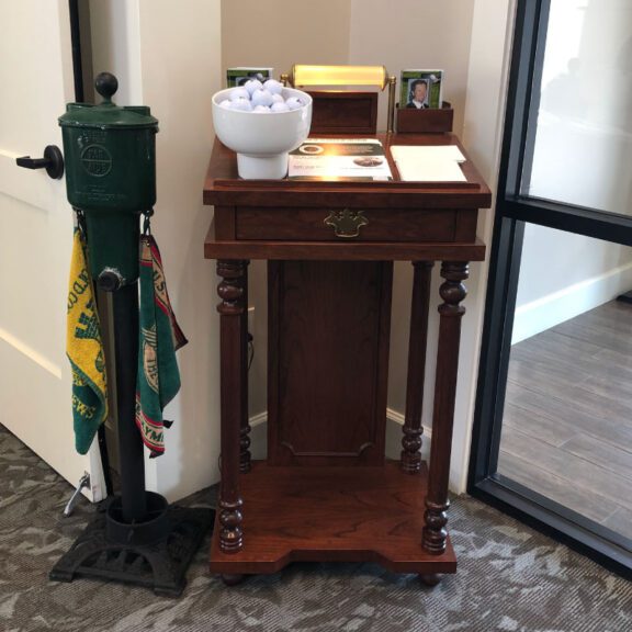 photo of a golf ball cleaning station next to a table with golf balls sitting in a bowl