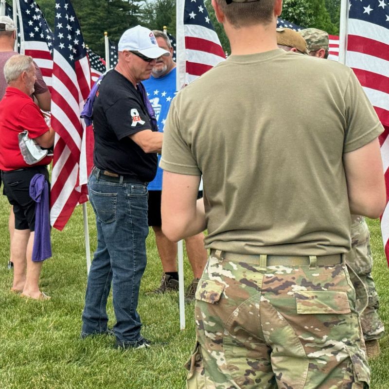 Volunteers placing American flags in the ground for Memorial Day