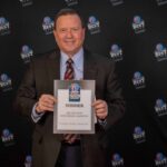 Photo of president Dan Applegate holding up a certificate for the Best Funeral Home & Crematory 2024 Award