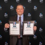 Photo of President Dan Applegate holding up the Best Locally Owned Business and the Top Employer award certificates