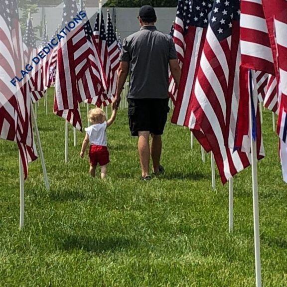 Father and Daughter Walking thru Field of Flags